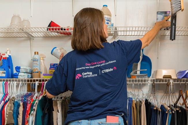 caring transition employee reorganizing closet